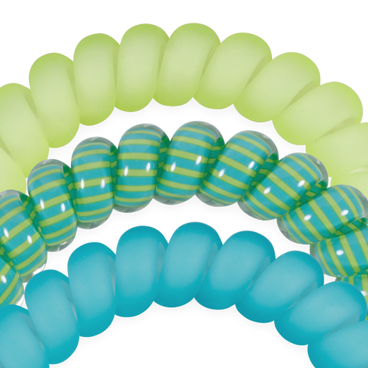 Close-up of green, blue, and striped rubber hair tie bands on a white background