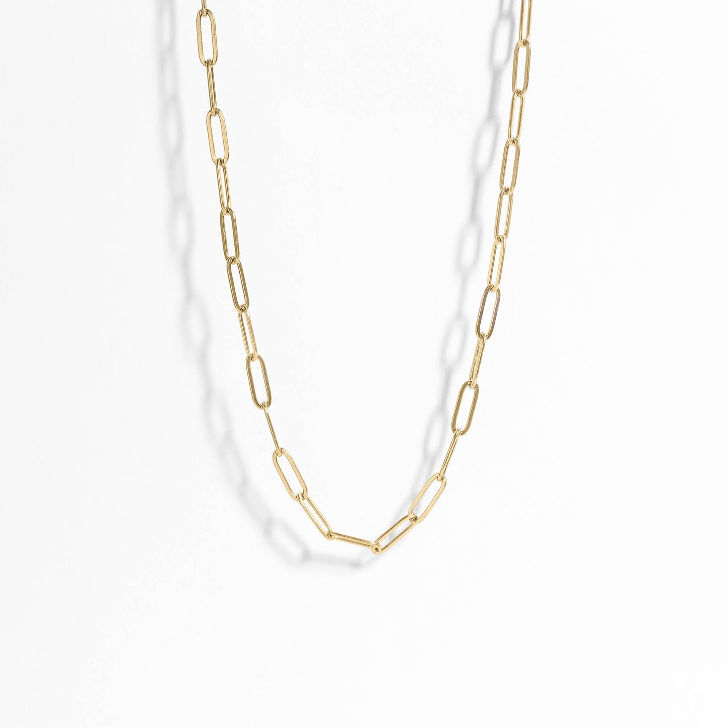 Gold chain necklace on a white background