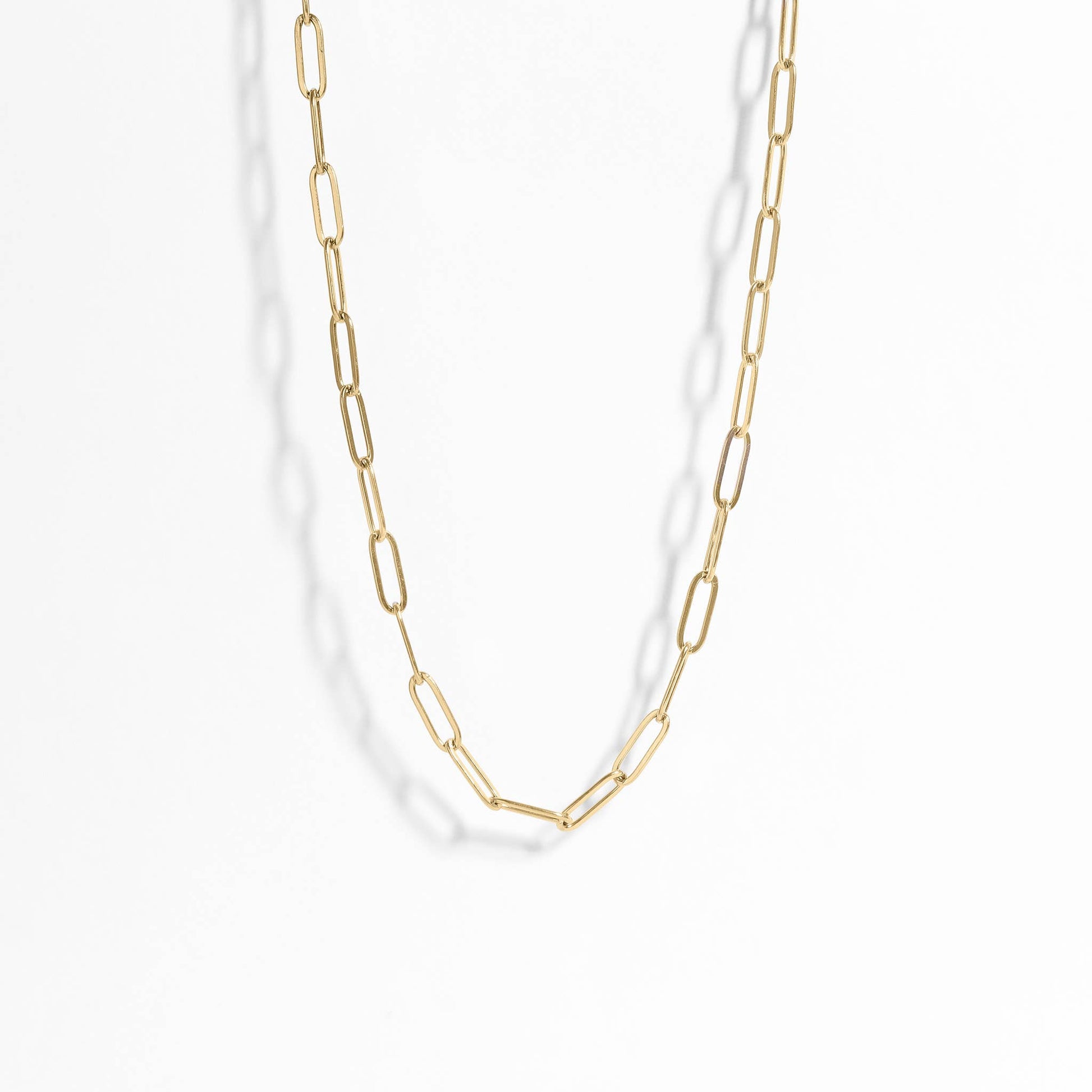 Gold chain necklace on a white background