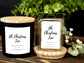Black candle and wax melt with 'Oh, Christmas Tree' label on a wooden surface with greenery in the background.
