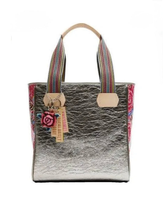 Handbag with floral design and colorful straps on a white background