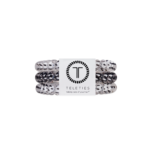 Set of white and black hair ties with a Teleties label on a white background