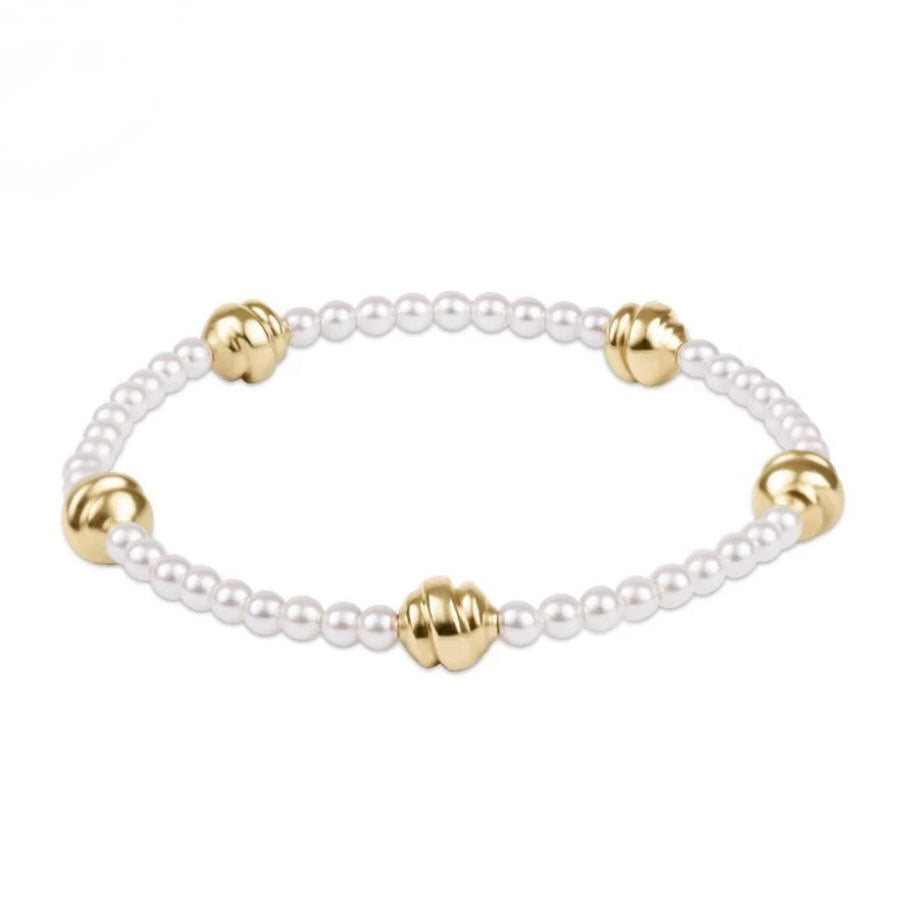Pearl bracelet with gold beads on a white background