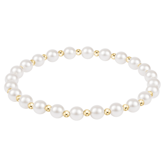 Pearl bracelet with gold beads on a white background
