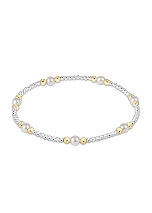Mixed metal beaded bracelet with pearls on a white background