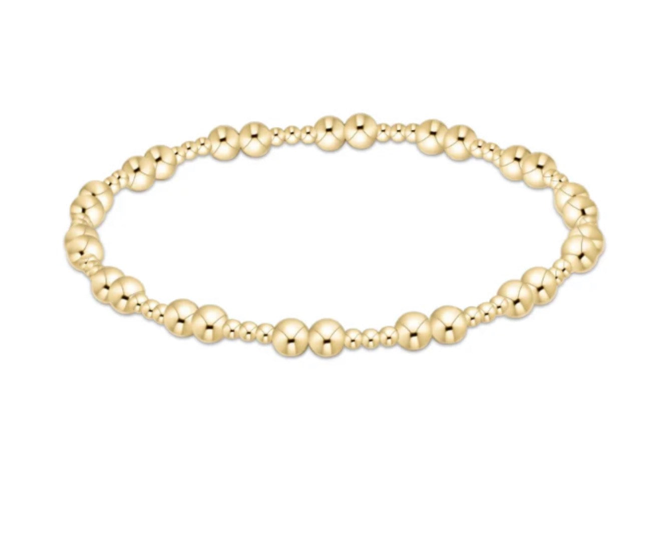 Gold beaded bracelet on a white background