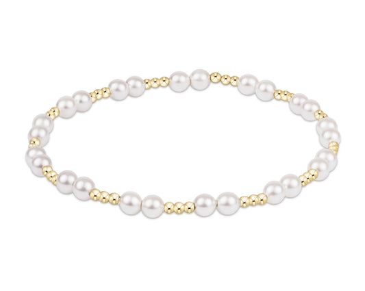 Pearl bracelet with gold accents on a white background