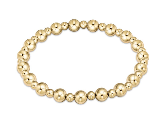 Gold enewton beaded bracelet on a white background