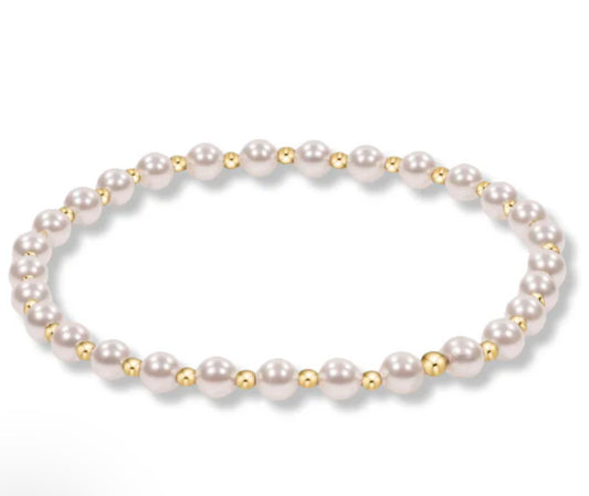 A classic gold beaded bracelet with alternating bead sizes, featuring 4mm pearls and 2mm gold-filled beads, hand beaded on elastic.