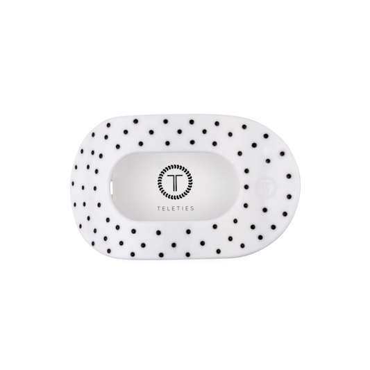 White pouch with black polka dots and 'Teleties' branding on a white background