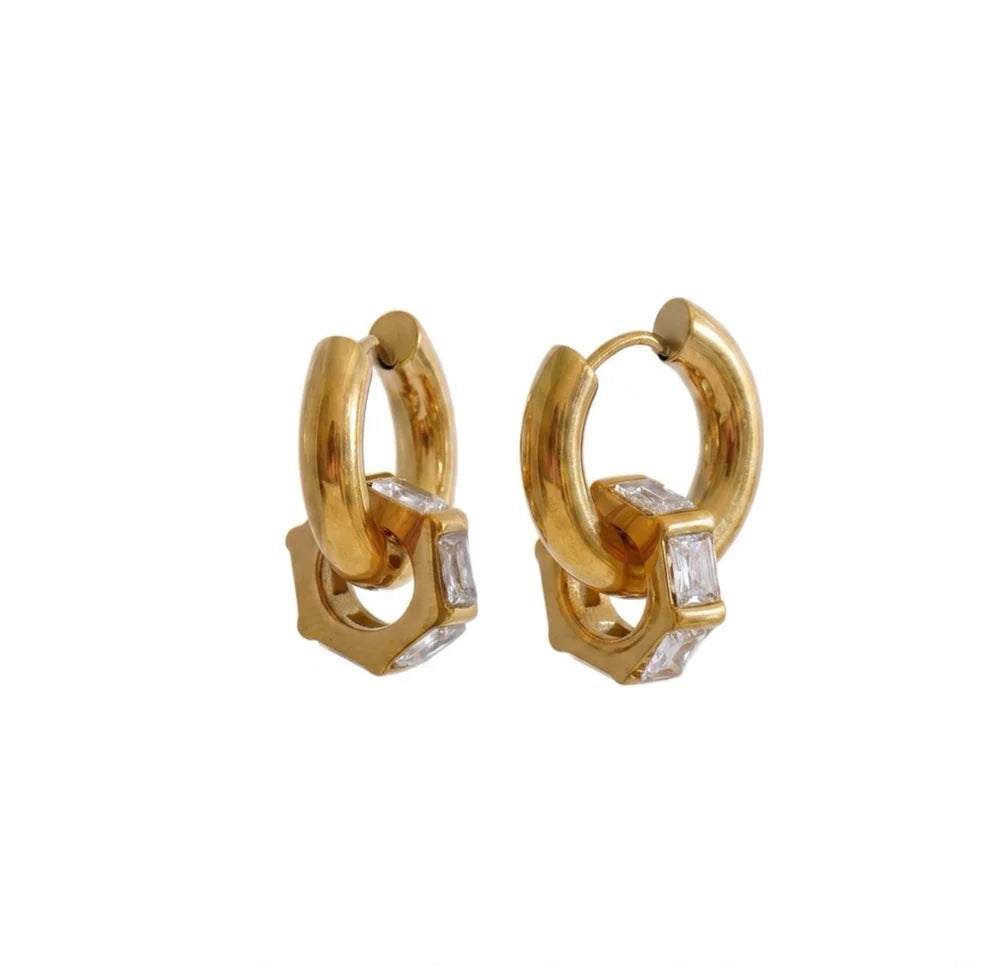 Gold hoop earrings with diamond accents on a white background