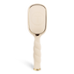 Gold paddle brush on a white background