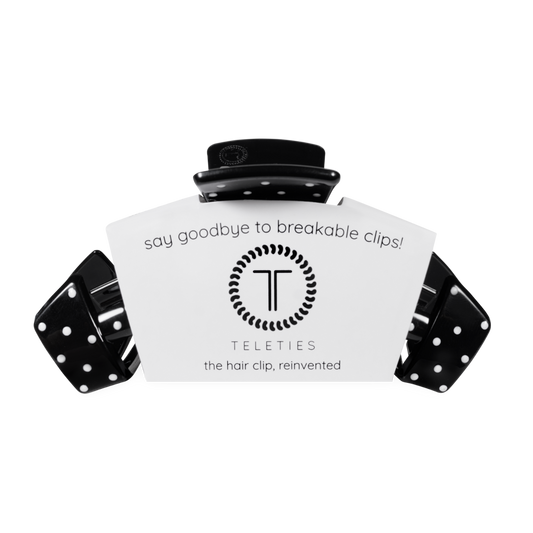 Black hair clip with white label displaying 'Teleties' on a white background