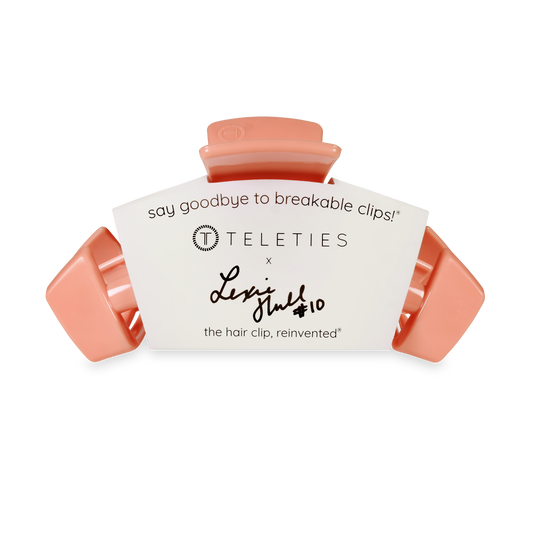 Coral hair clip with white label featuring 'Teleties' branding on a white background