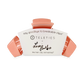 Coral hair clip with white label featuring 'Teleties' branding on a white background