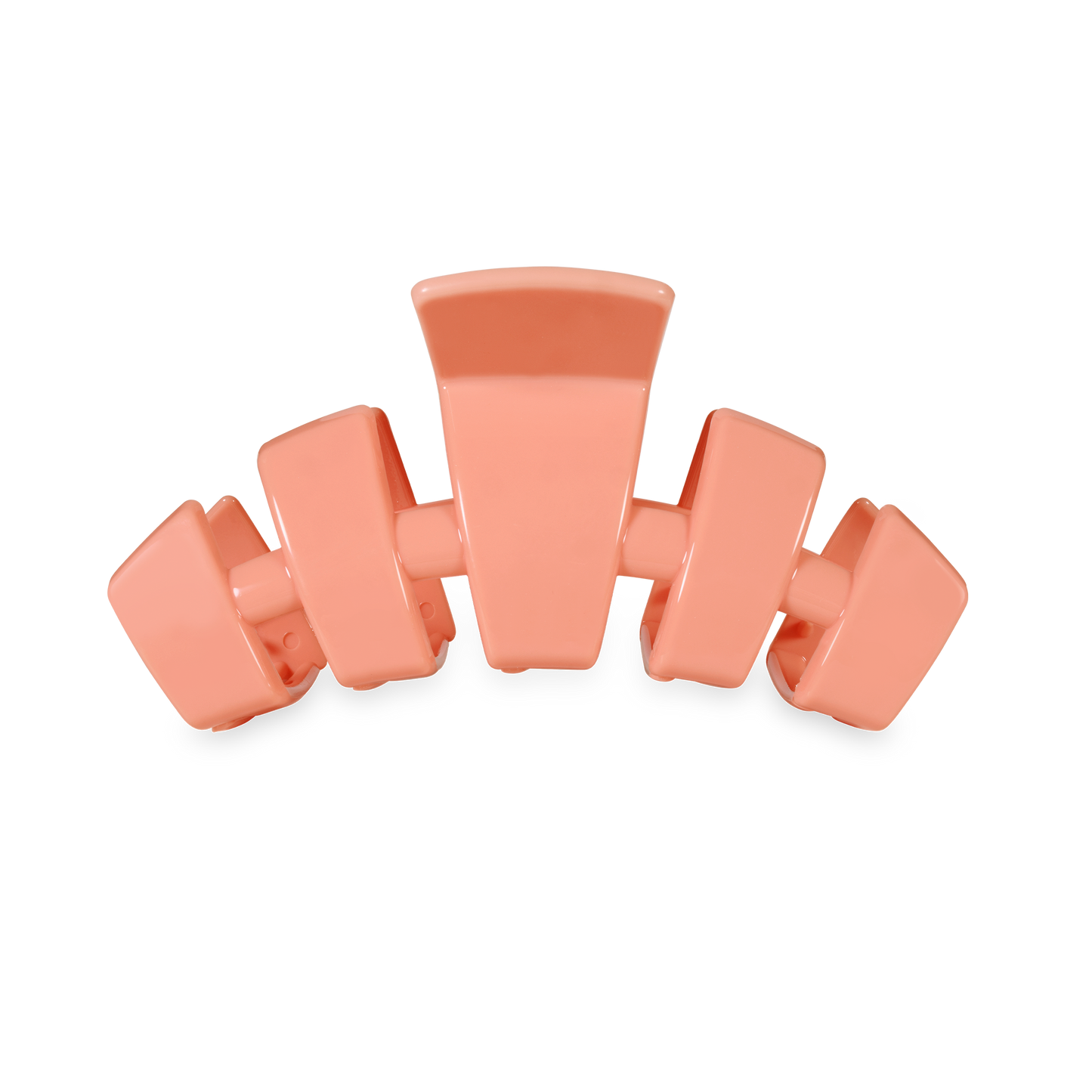 Coral-colored hair clip on a white background