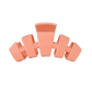 Coral-colored hair clip on a white background