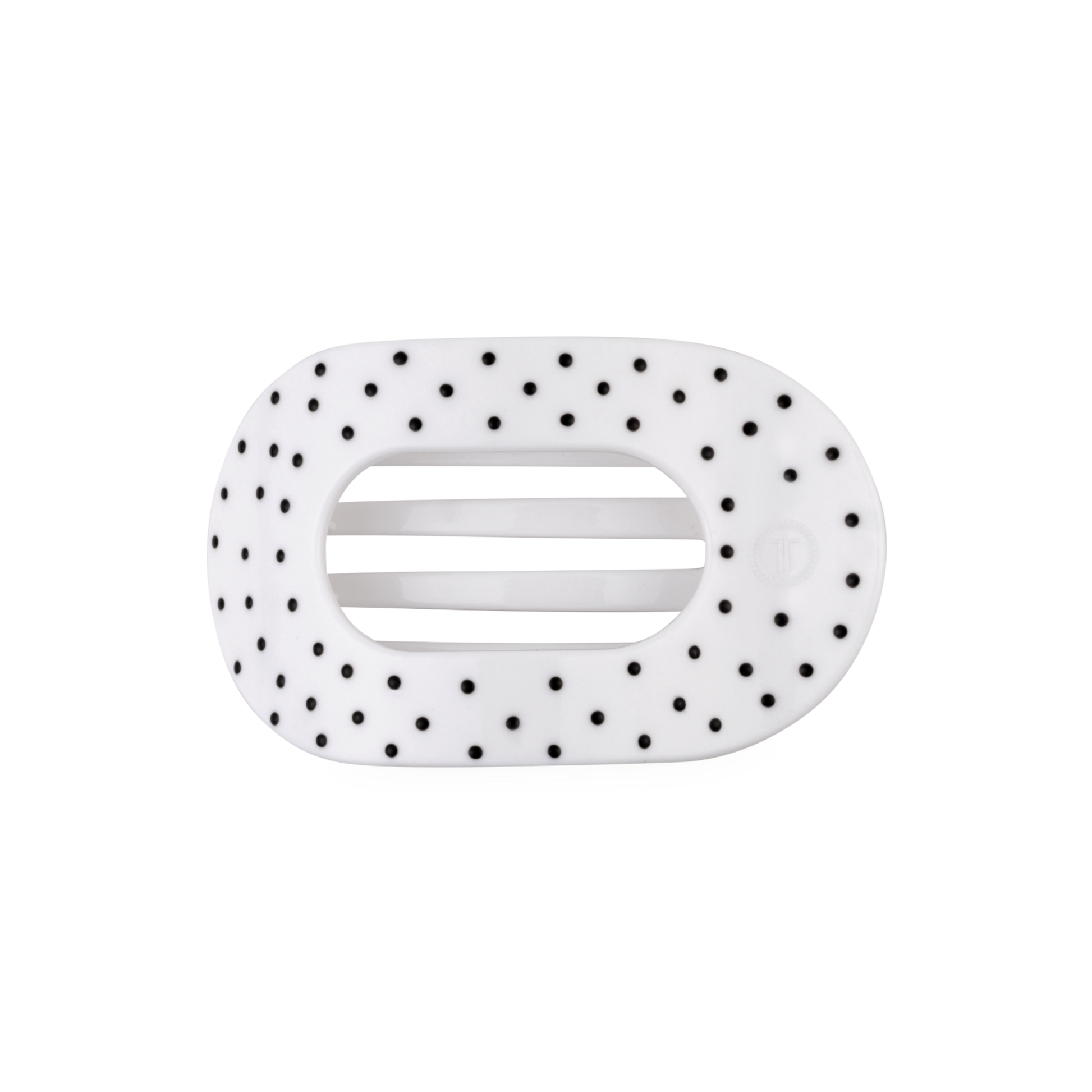 White hair clip with black polka dots on a white background