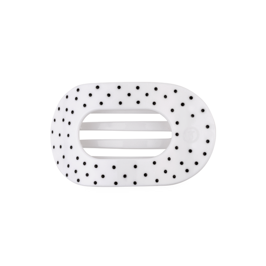 White hair clip with black polka dots on a white background