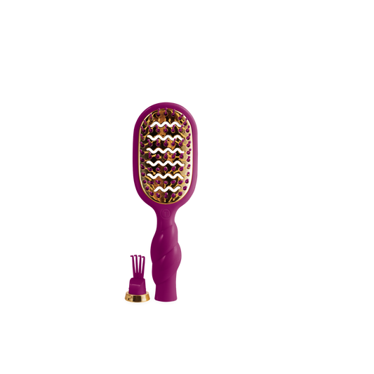 A purple hairbrush with gold-toned bristles and a matching purple and gold brush attachment, shown on a plain white background.