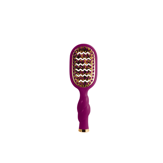 A purple and gold paddle hairbrush centered on a plain white background.