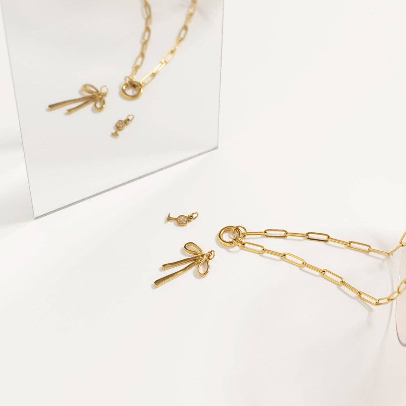 Gold jewelry set including necklace, earrings, and rings on a white background