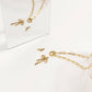 Gold jewelry set including necklace, earrings, and rings on a white background