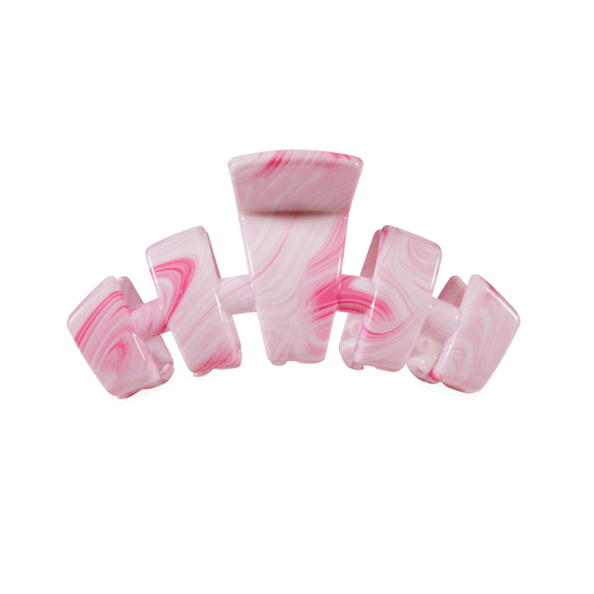 Pink and white marbled hair clip on a white background