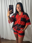 Women's red and black striped half zip short sleeve top and matching drawstring shorts set
