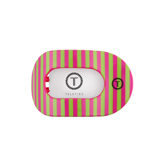 Round hair clip with pink and green striped pattern on a white background