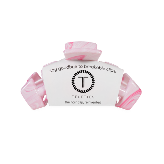 Pink hair clip with teleties white label on a white background