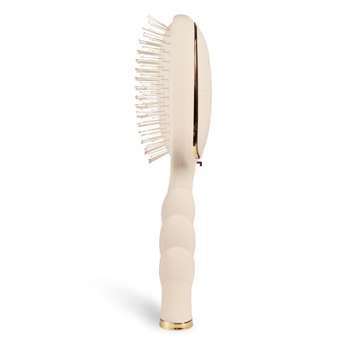 Tan hairbrush with gold accents on a white background