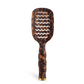 Leopard print paddle hairbrush on a white background