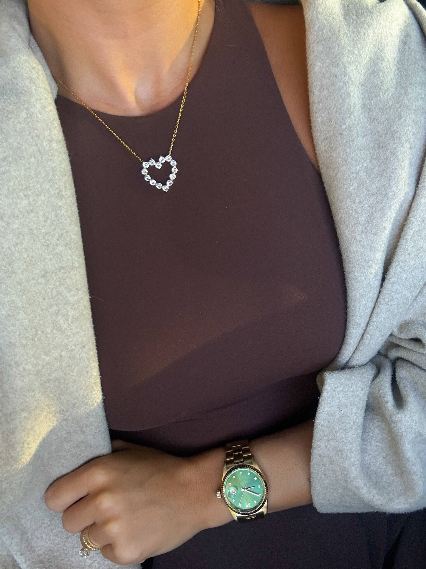 Gold heart pendant necklace with crystal accents on a delicate chain