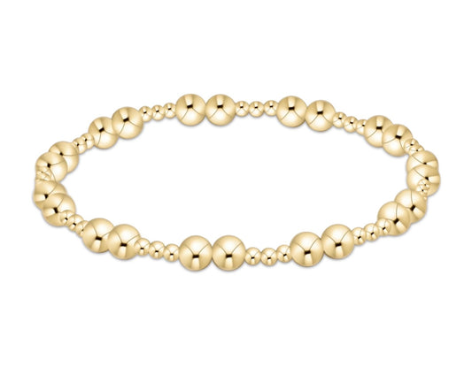 Gold enewton beaded bracelet on a white background