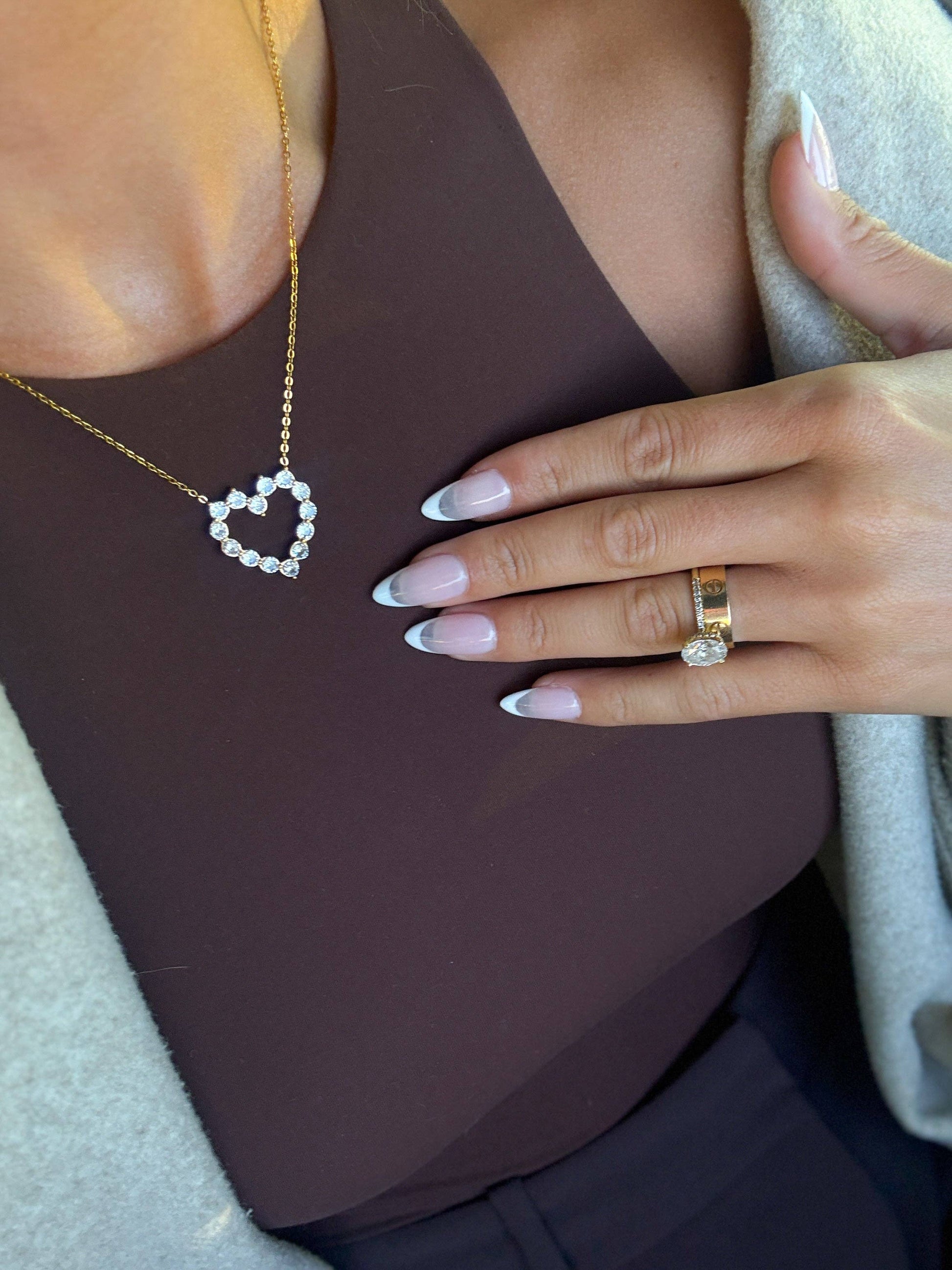 Gold heart pendant necklace with crystal accents on a delicate chain