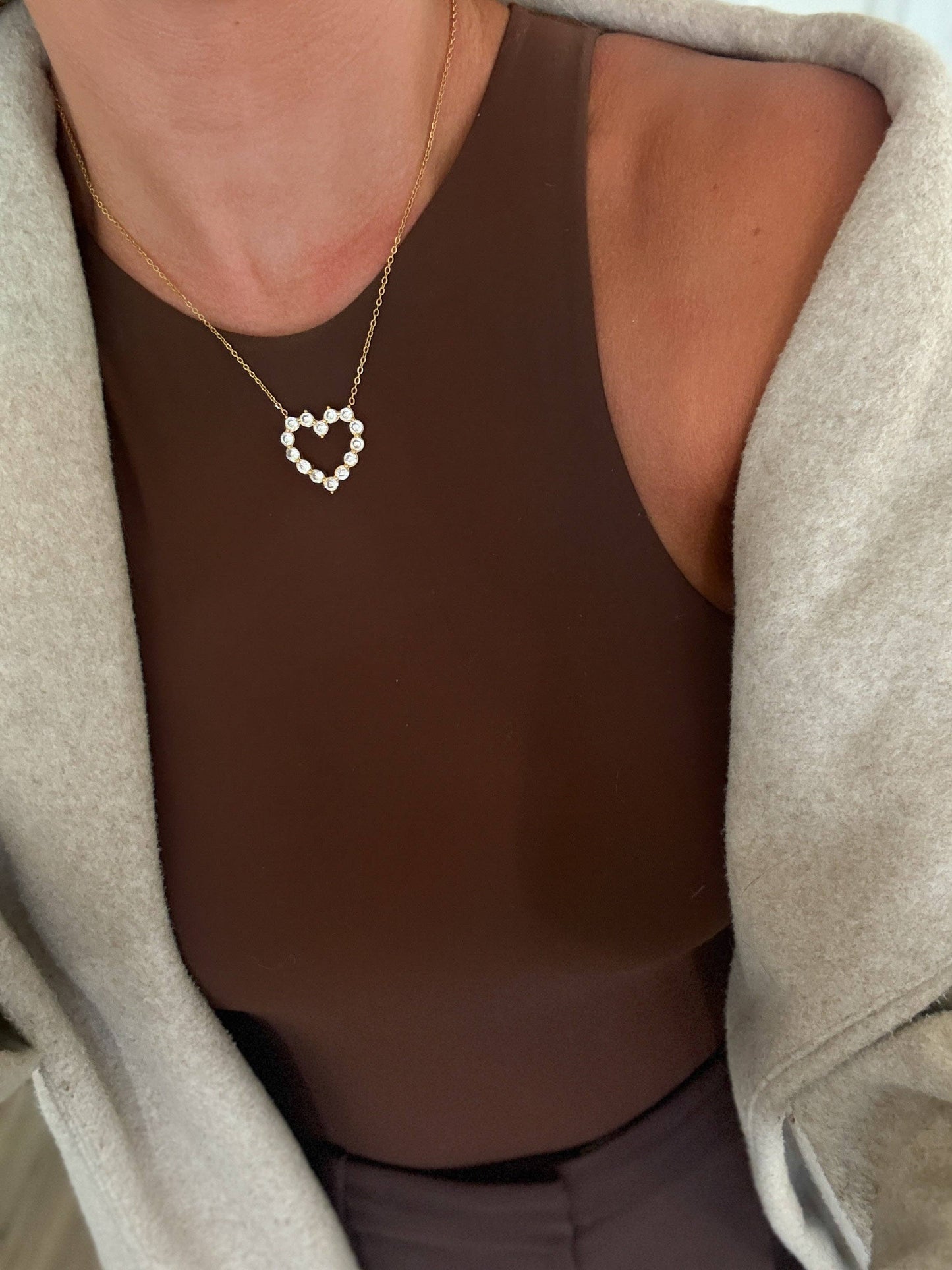 Gold heart pendant necklace with crystal accents on a delicate chain