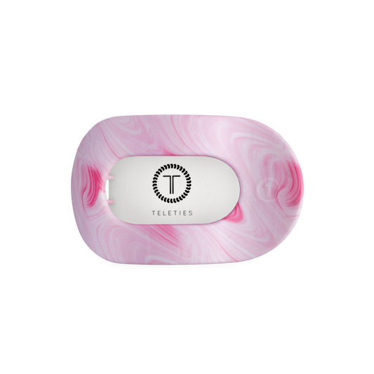 Pink marbled soap with 'Teleties' logo on a white background