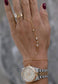 Delicate gold hand chain bracelet with gold accent diamonds