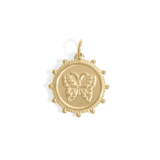 Gold pendant with butterfly design on a white background