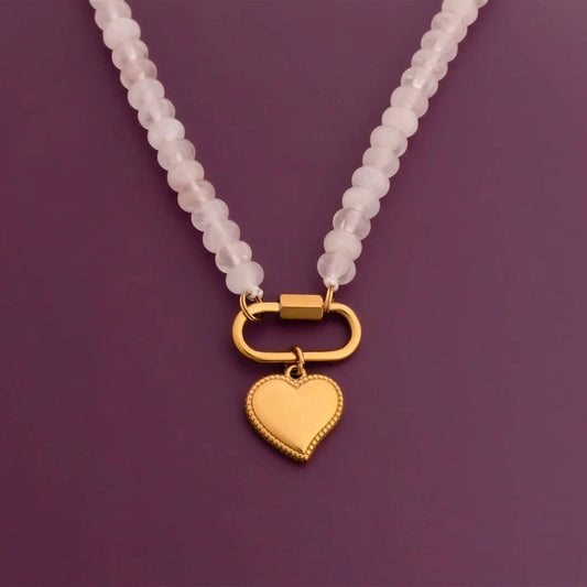 Necklace with a gold heart pendant on a purple background