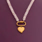Necklace with a gold heart pendant on a purple background