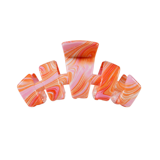 Set of colorful hair clips with pink and orange marbled pattern on a white background