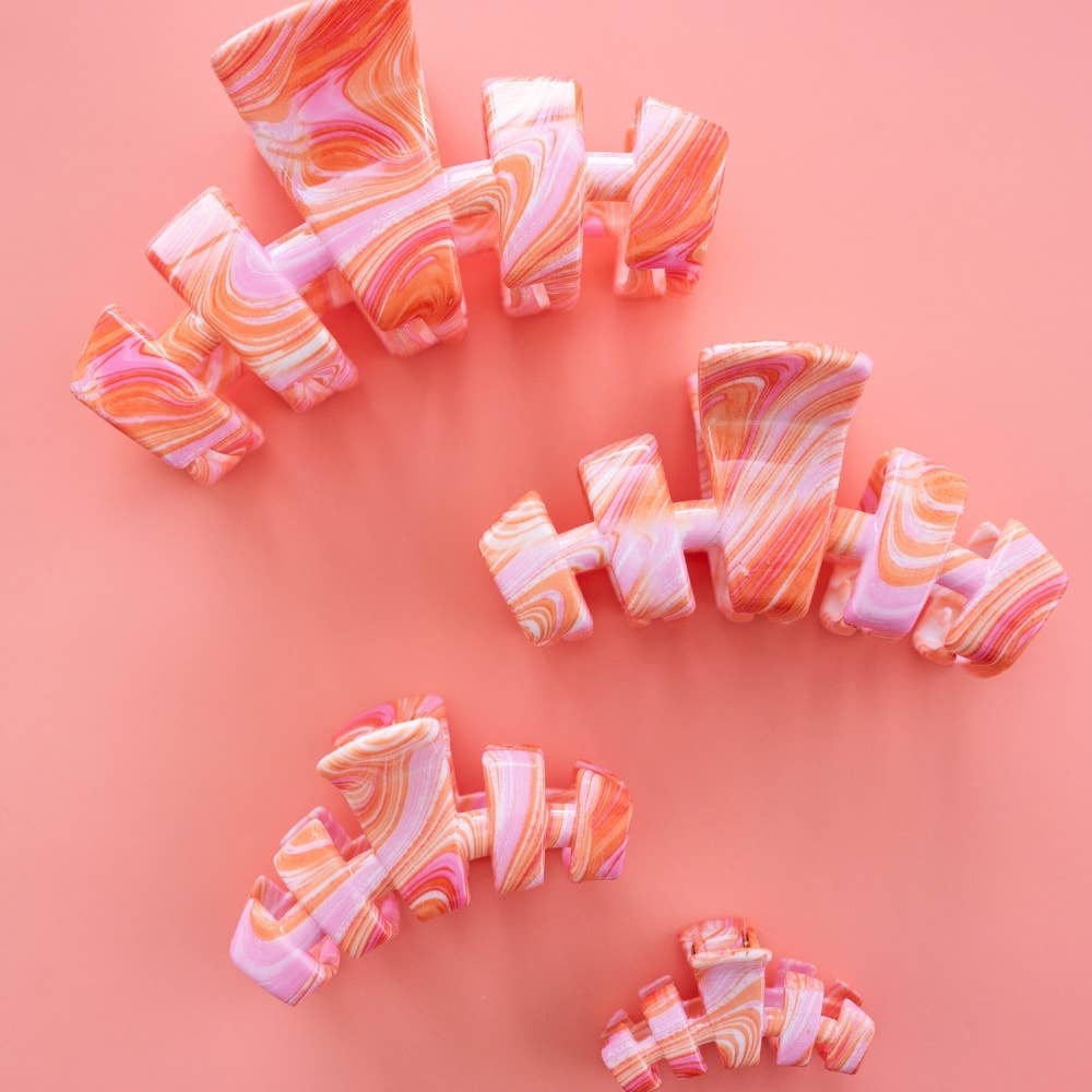 Marbled hair ties on a pink background