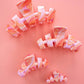Marbled hair ties on a pink background