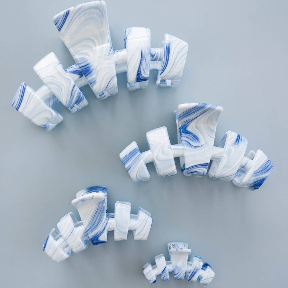 Marble-patterned hairclips on a gray background