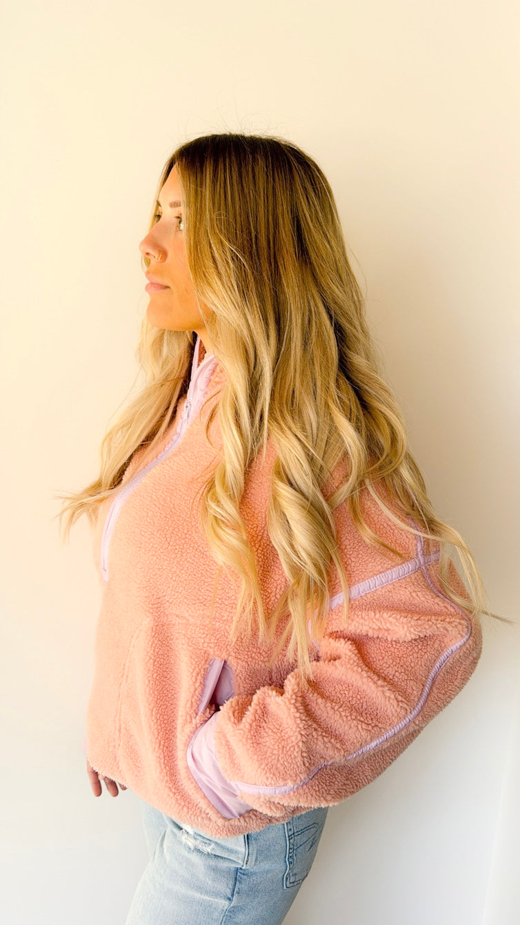 Side view of model wearing a two toned Sherpa pullover with hand in pocket