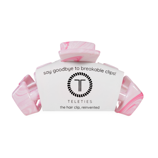Pink hair clip with a teleties label on a white background