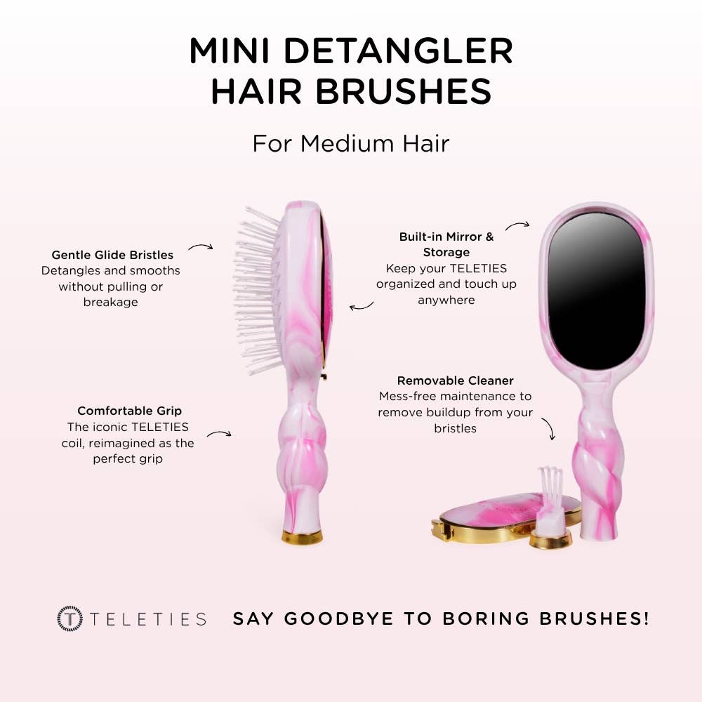 Pink mini detangler hair brush with mirror and cleaning tool on a white background