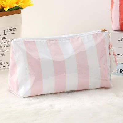 Pink and white striped pouch on a light surface with text in the background